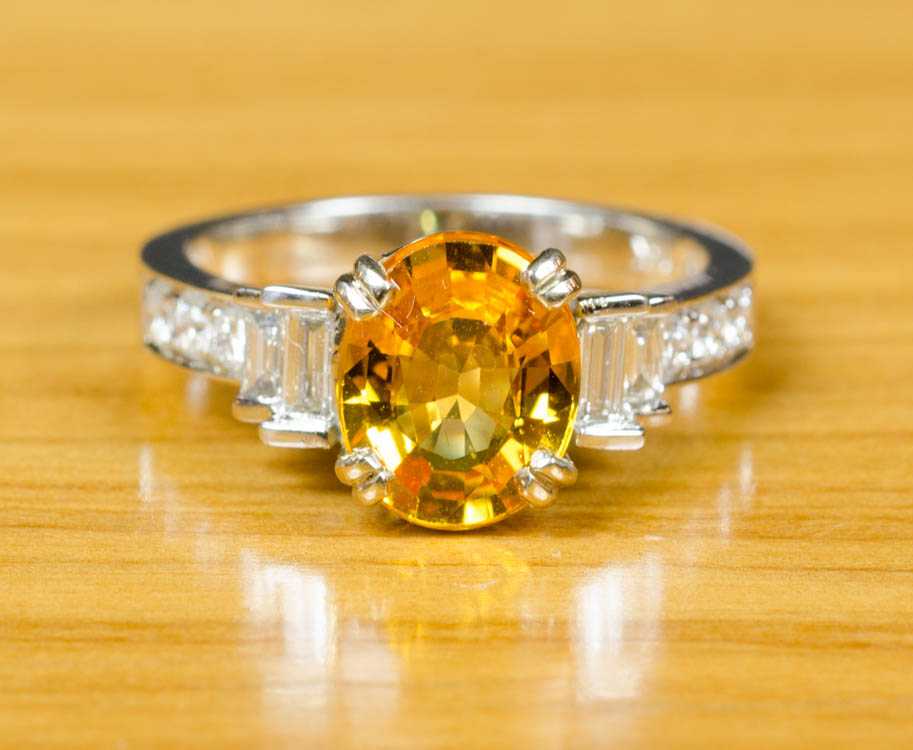 Appraisal: YELLOW SAPPHIRE AND FOURTEEN KARAT GOLD RING The white and