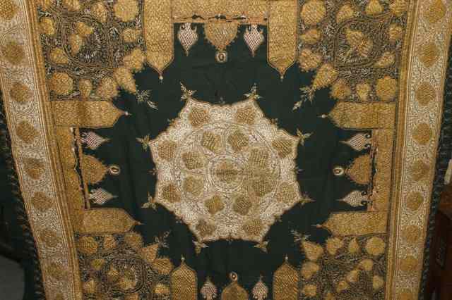 Appraisal: AN INDIAN GOLD THREAD SQUARE PANEL with central stylised flower