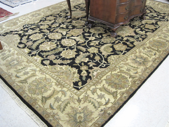 Appraisal: HAND KNOTTED ORIENTAL CARPET Indo-Persian the rectangular black field and