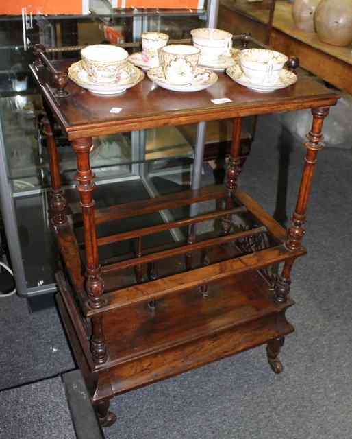 Appraisal: A VICTORIAN WALNUT CANTERBURY with carved decoration turned spindles and