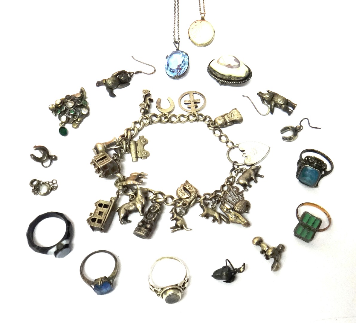 Appraisal: A silver curb link charm bracelet with a silver heart