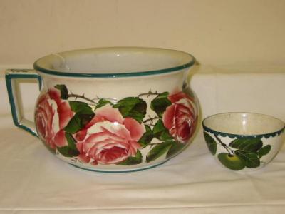 Appraisal: A WEMYSS EARTHENWARE CHAMBER POT painted in typical palette with