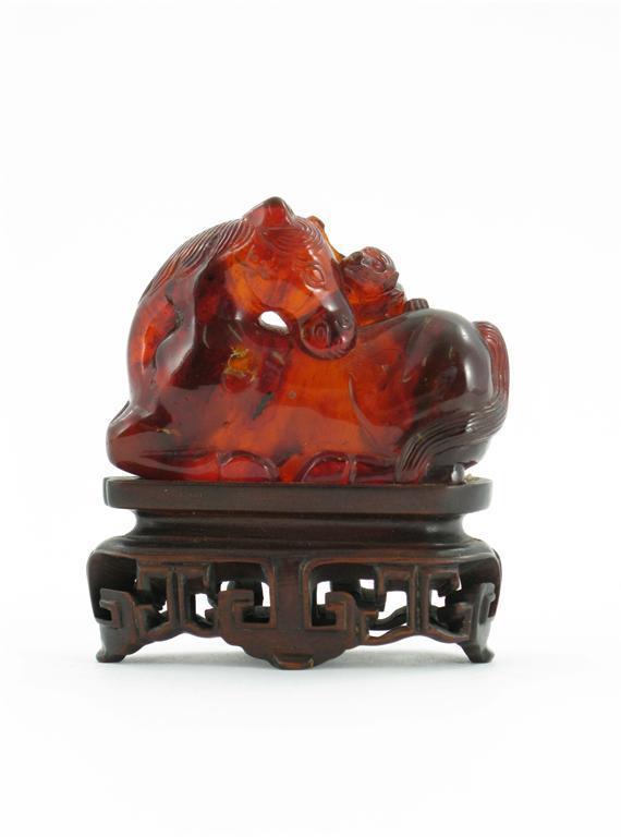 Appraisal: A Chinese amber carving of a recumbent horse