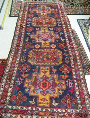 Appraisal: PERSIAN TRIBAL HALL CARPET the dark blue field decorated with