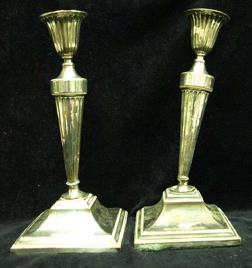 Appraisal: A pair of Sheffield plate candlesticks each with fluted column