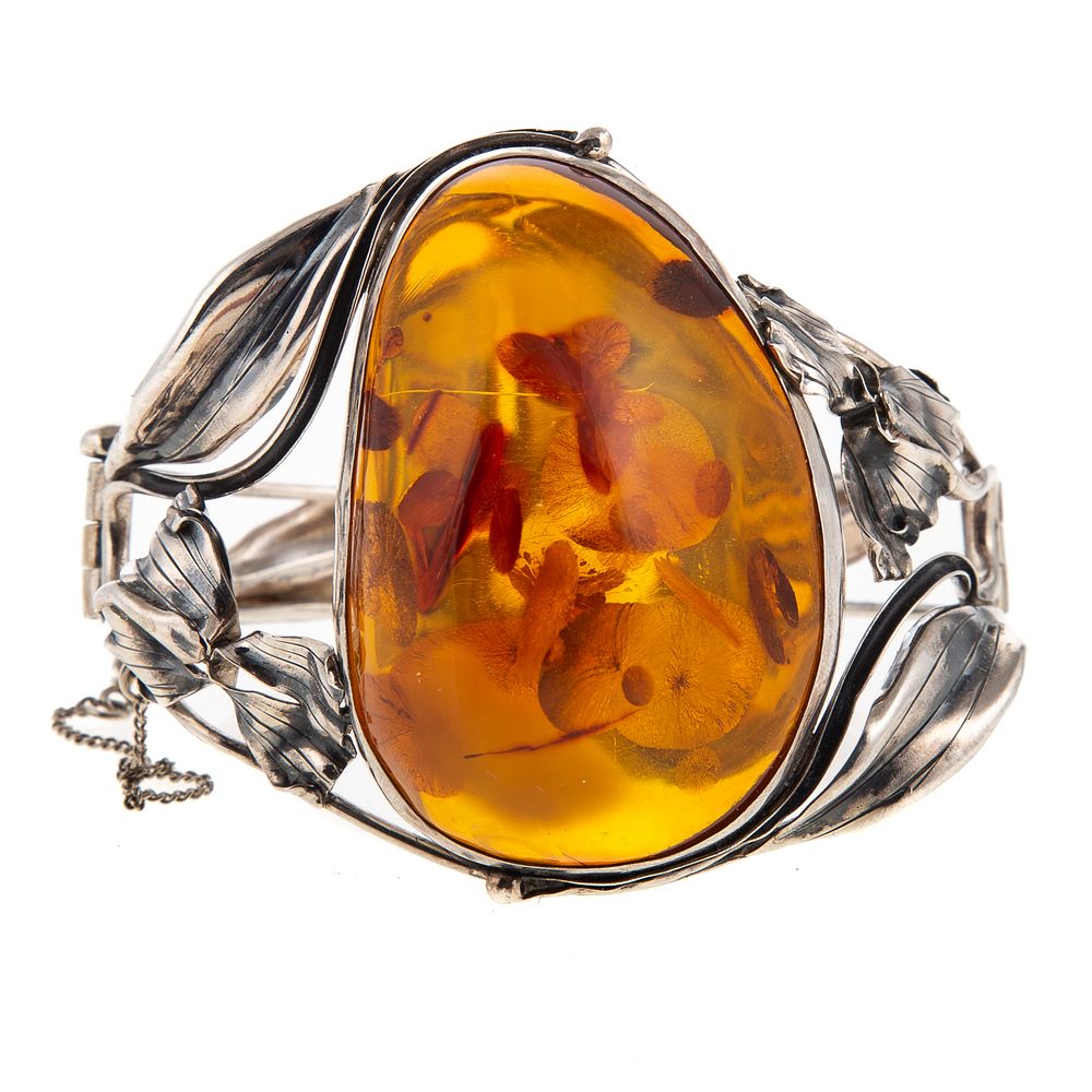 Appraisal: A Swedish Silver Amber Bangle Swedish silver hinged bangle featuring