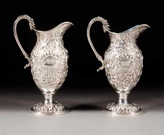 Appraisal: Near pair of American Classical repousse sterling silver pitchers Andrew