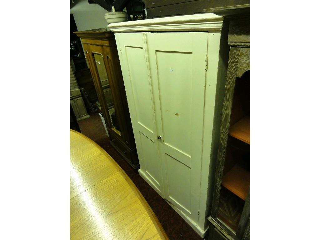 Appraisal: A painted pine freestanding side cupboard with simple stepped and