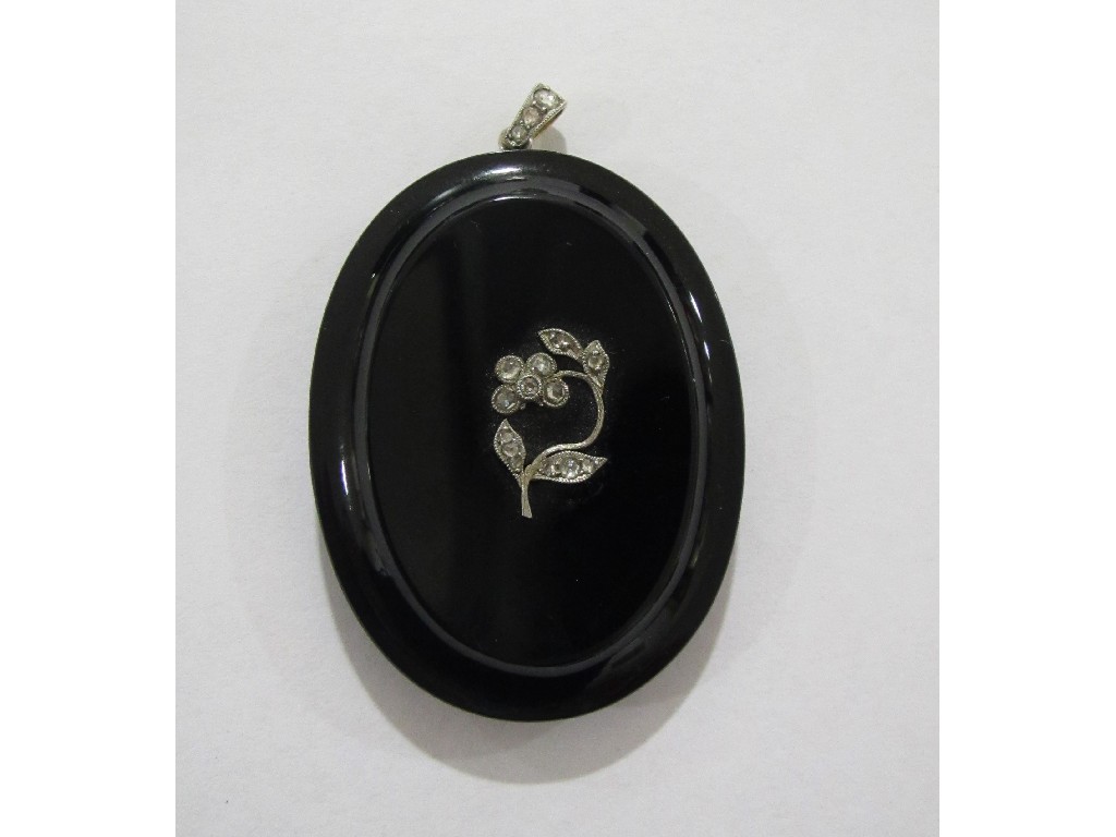 Appraisal: Jet mourning pendant of oval form with white metal flower