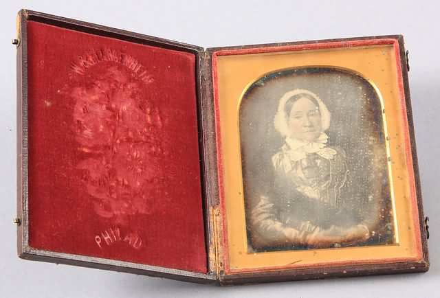 Appraisal: Quarter plate daguerreotype of well dressed woman waist up Pad