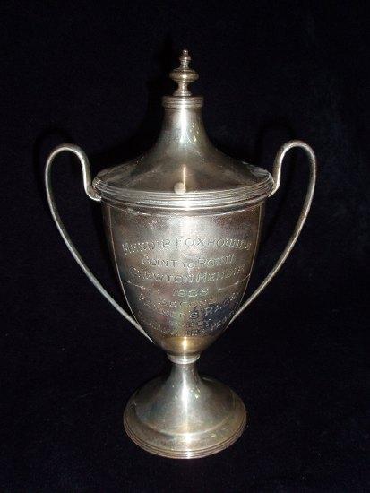 Appraisal: A trophy cup of lidded form with reeded rims on