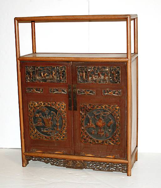 Appraisal: A soft wood display cabinet with carved and painted doors