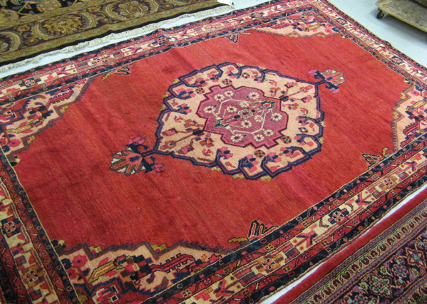 Appraisal: PERSIAN KURDISH TRIBAL CARPET centering a large floral medallion on