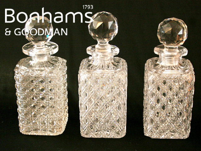 Appraisal: Three diamond cut decanters and stoppers some damage Three diamond