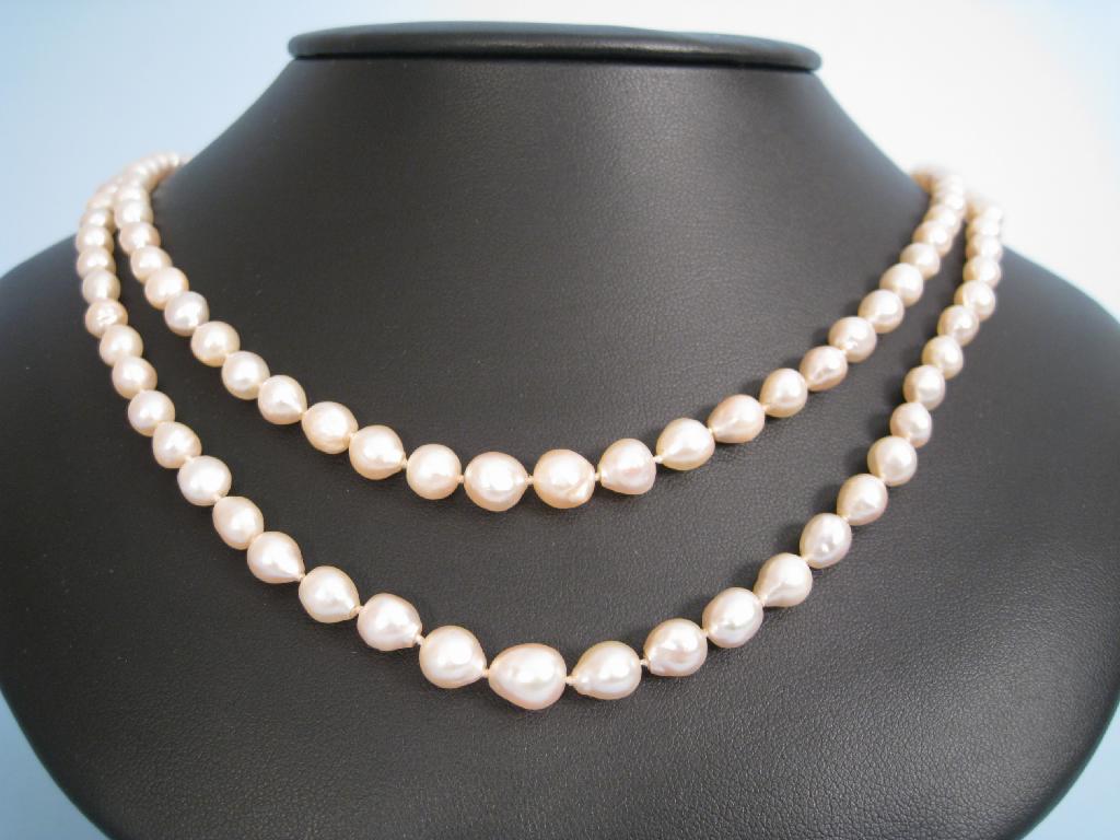 Appraisal: A double row of graduated Freshwater Pearls with paste-set clasp