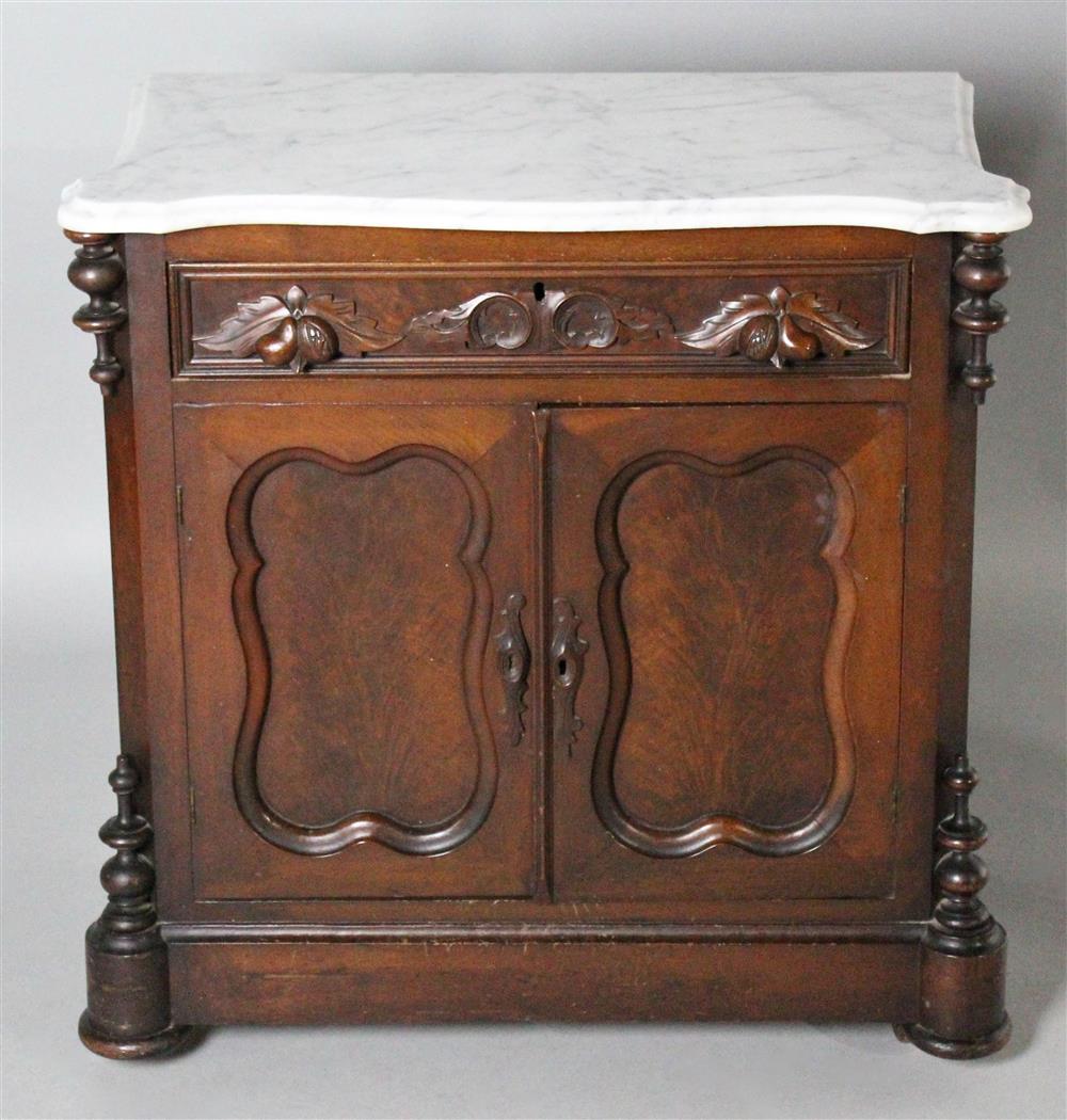 Appraisal: VICTORIAN CARVED MAHOGANY SMALL CABINET WITH MARBLE TOP the shaped