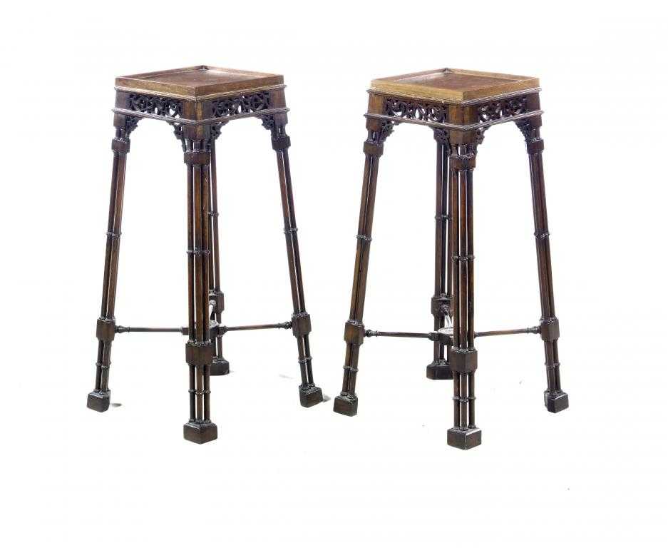 Appraisal: A PAIR OF MAHOGANY URN STANDS the galleried square top