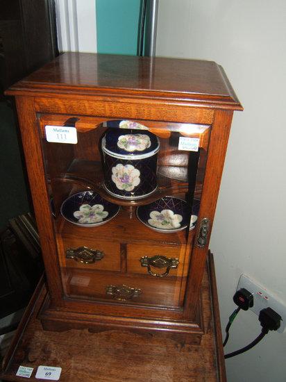 Appraisal: An Edwardian oak smokers cabinet with porcelain fittings and three