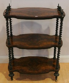 Appraisal: A Victorian walnut three tiered whatnot on barley twist supports