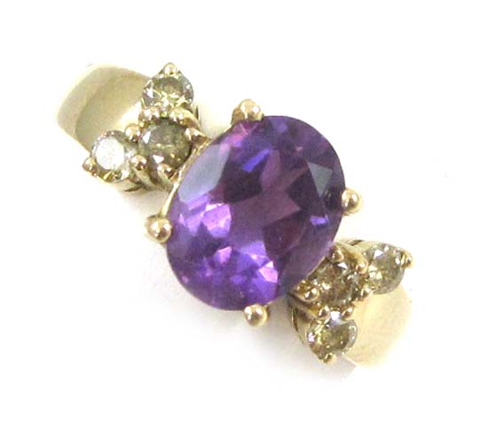 Appraisal: AMETHYST DIAMOND AND FOURTEEN KARAT GOLD RING featuring an oval-cut