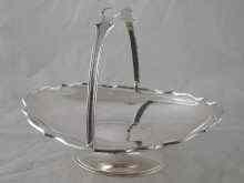 Appraisal: A swing handled cake basket with shaped stiffened rim on