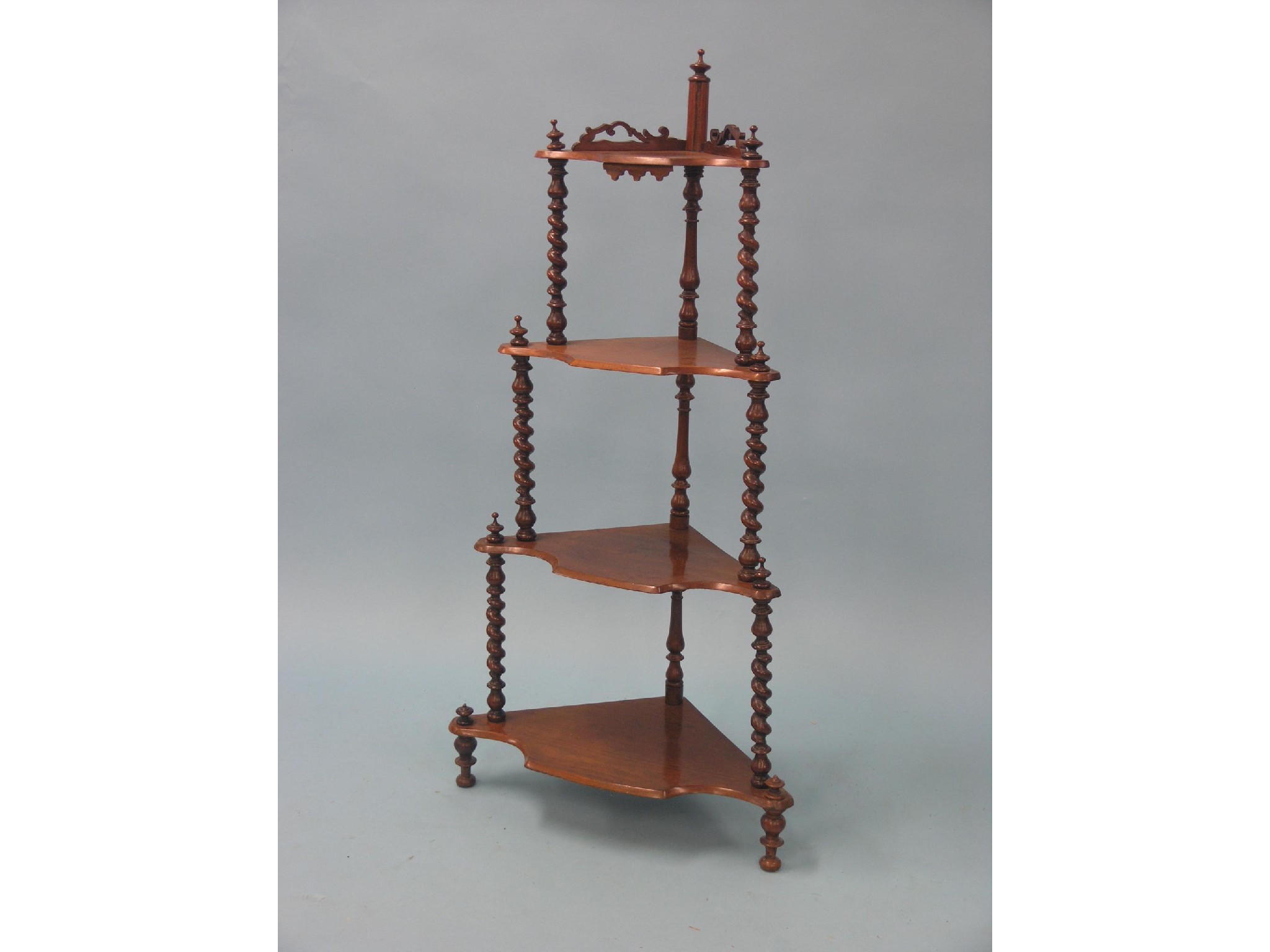 Appraisal: A Victorian walnut whatnot four shaped tiers between spiral-twist supports