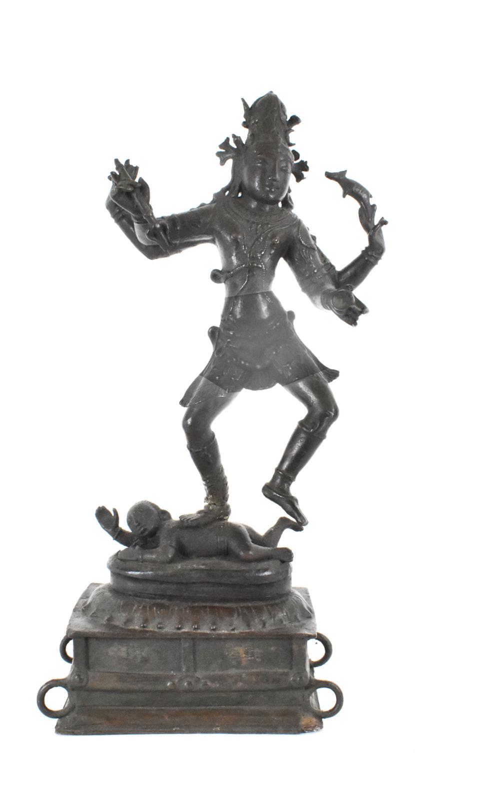 Appraisal: INDIAN PATINATED BRONZE OF SHIVAThe four-armed deity in a pleated