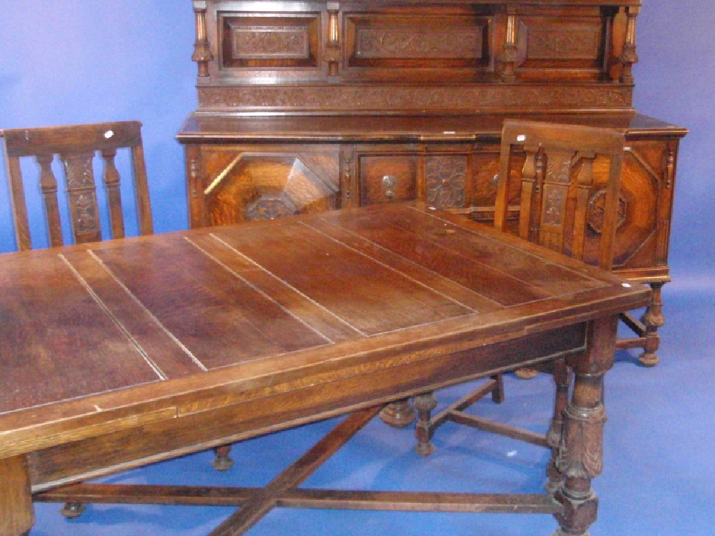 Appraisal: A heavy carved oak dining room suite comprising sideboard draw