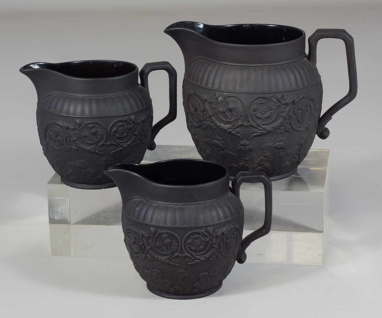 Appraisal: Wedgwood black jasper cream pitchers with leaf floral design tallest