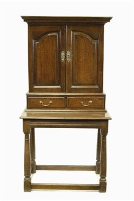 Appraisal: An oak cabinet the moulded cornice above a pair of