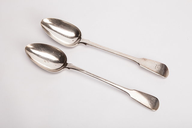 Appraisal: TWO GEORGIAN SILVER FIDDLE PATTERN TABLE SPOONS both monogrammed London