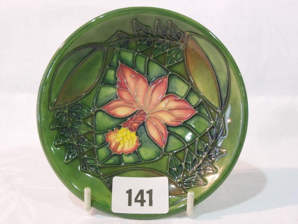 Appraisal: A Moorcroft green ground dish of circular form with pink