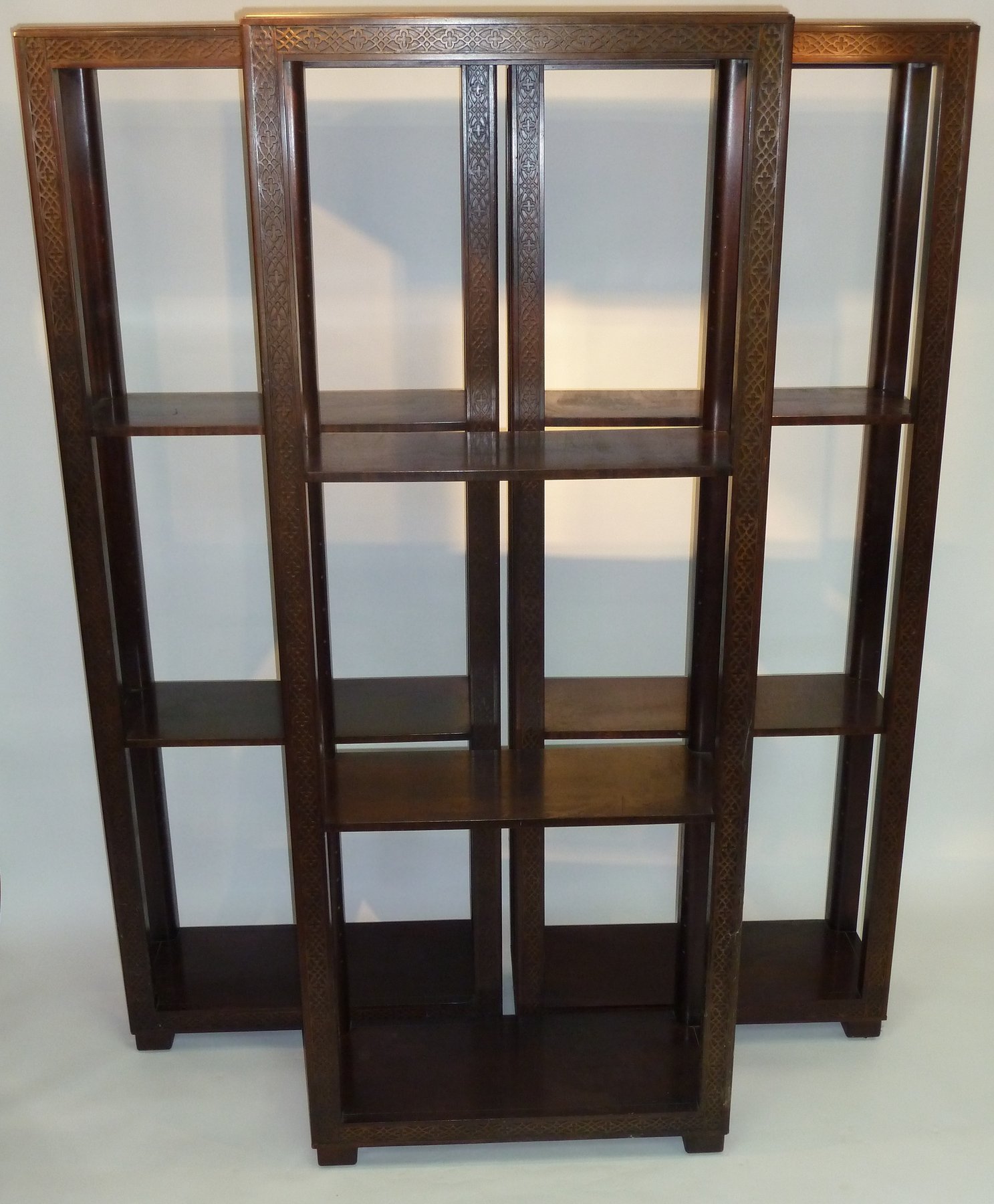 Appraisal: Three open bookcases each with blind fret carved decoration to