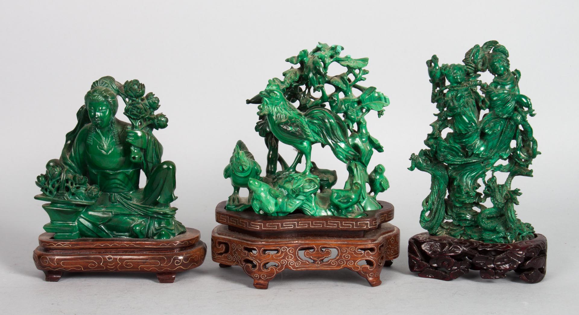 Appraisal: Three Chinese carved malachite figural groups seated Quan-Yin on wood