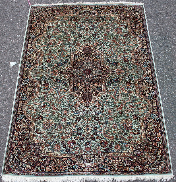 Appraisal: A PERSIAN PALE BLUE GROUND PART SILK RUG the central