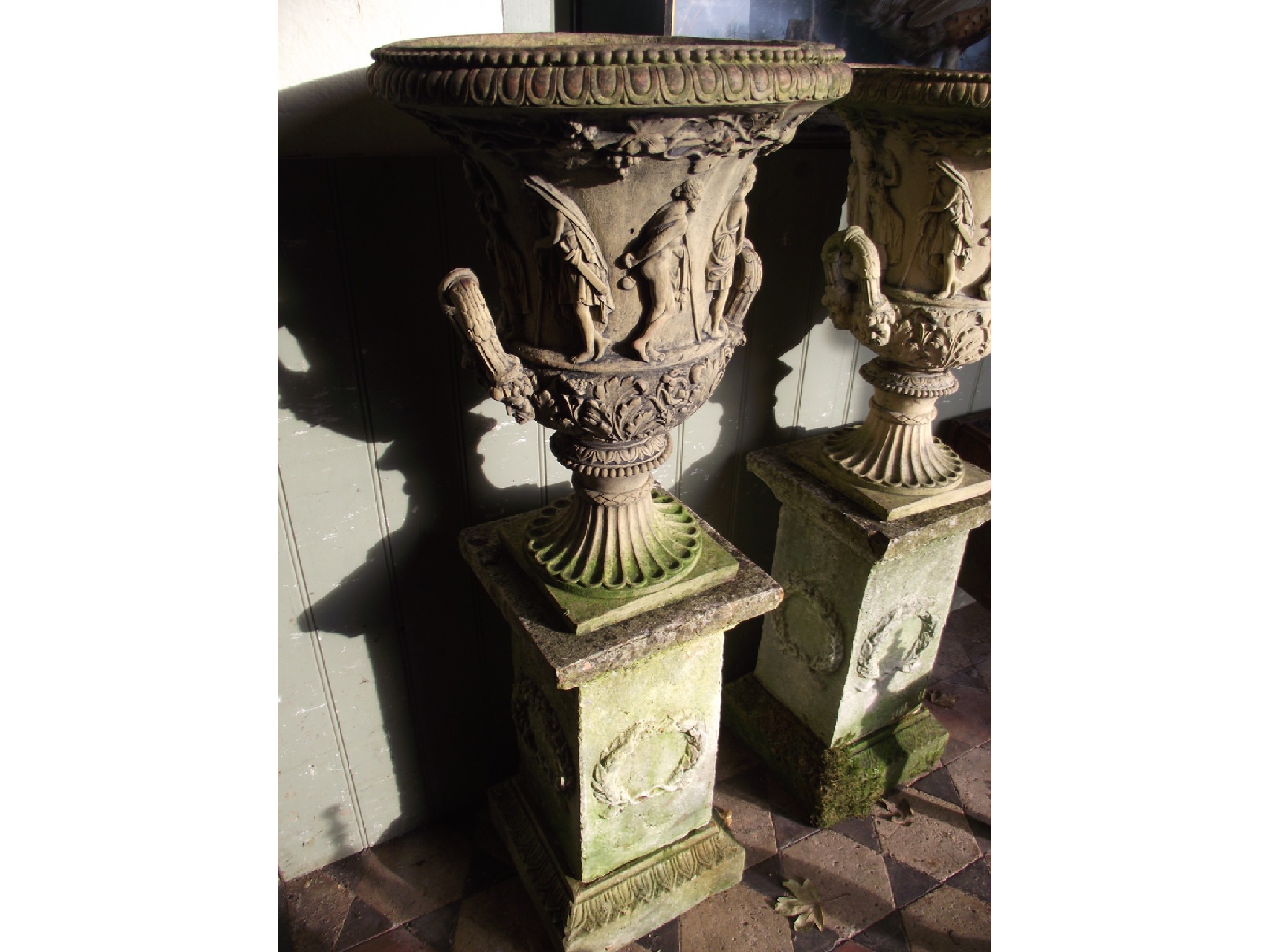 Appraisal: A pair of small weathered terracotta campana shaped garden urns