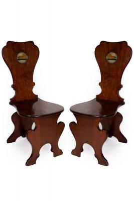 Appraisal: A pair of early George III mahogany sgabello hall chairs