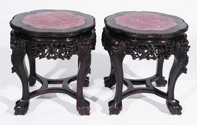 Appraisal: A pair of Chinese hardwood circular urn standseach with inset