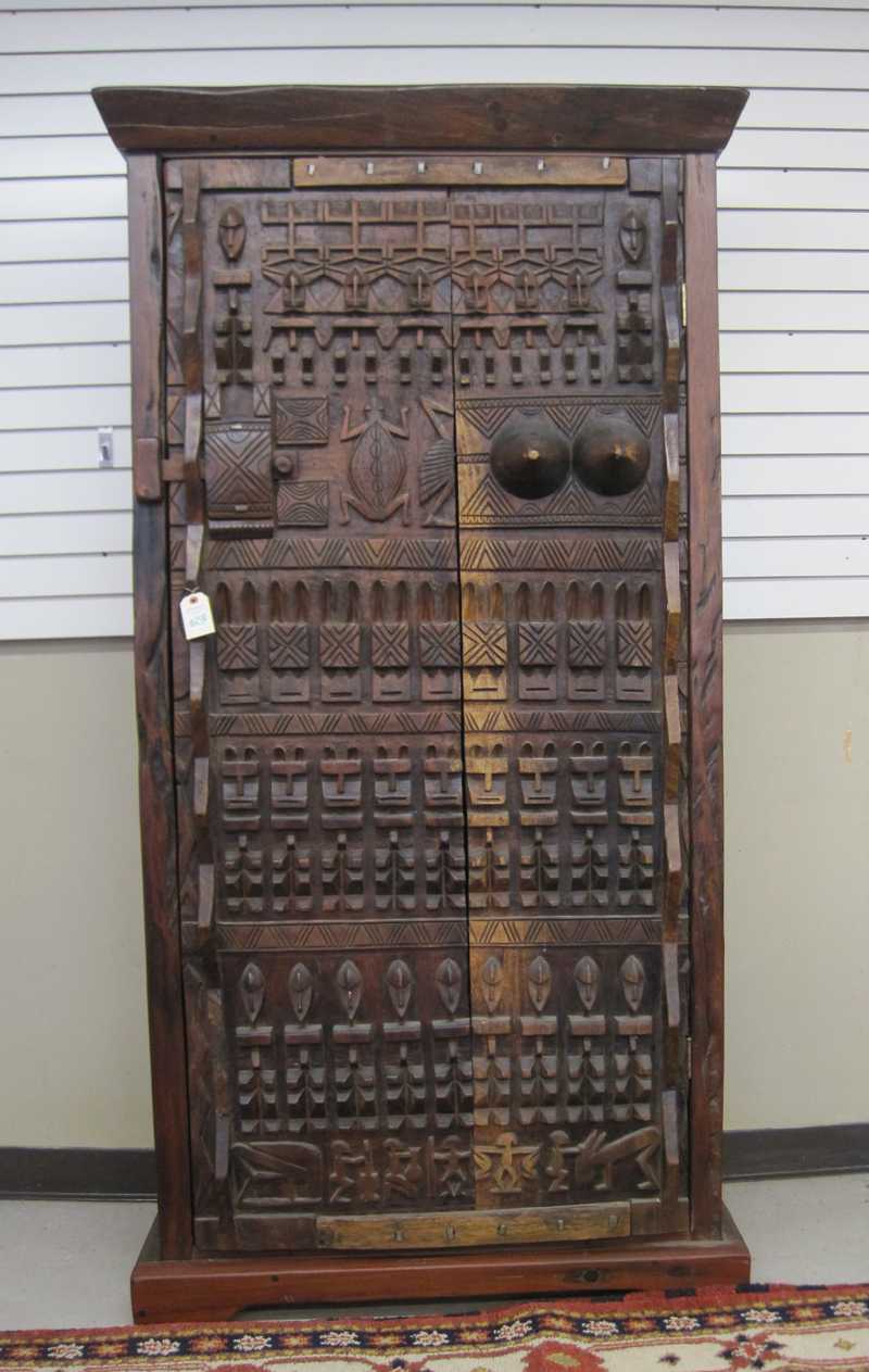 Appraisal: AFRICAN TRIBAL WARDROBE a custom crafted mahogany wardrobe using a