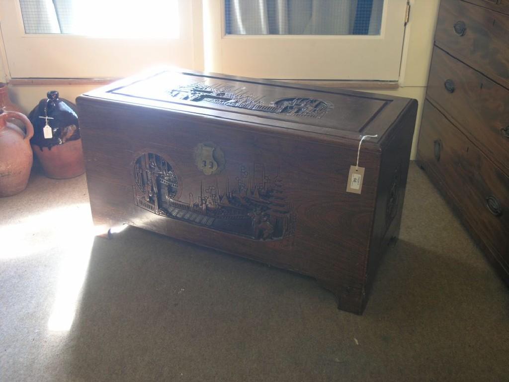 Appraisal: A Chinese carved camphorwood blanket chest complete with interior tray