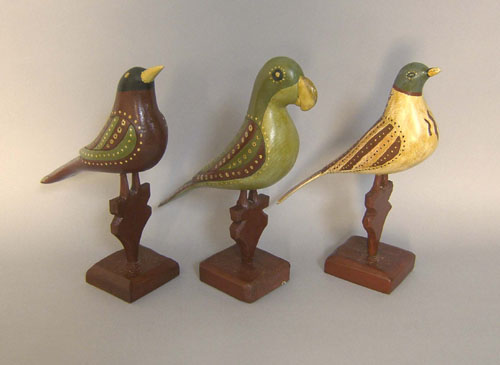 Appraisal: Three carved and painted birds in the manner of the