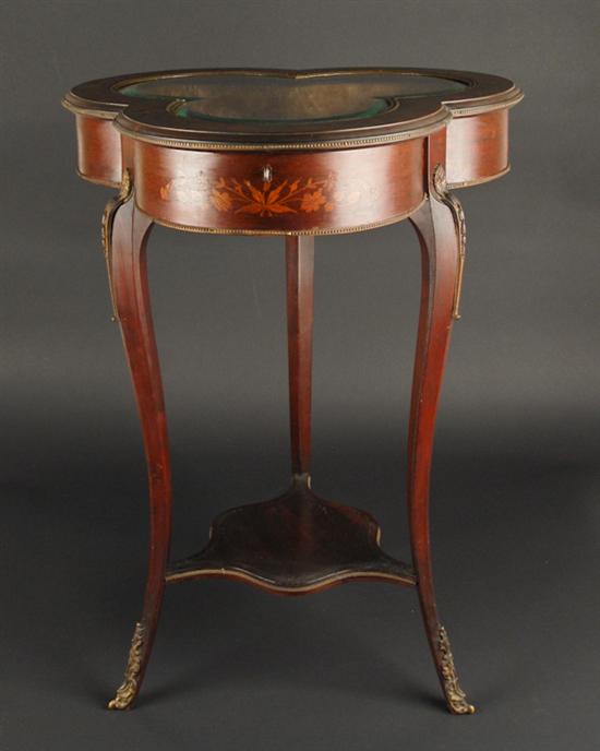 Appraisal: A French Marquetried Trefoil Display Table having a glass insert