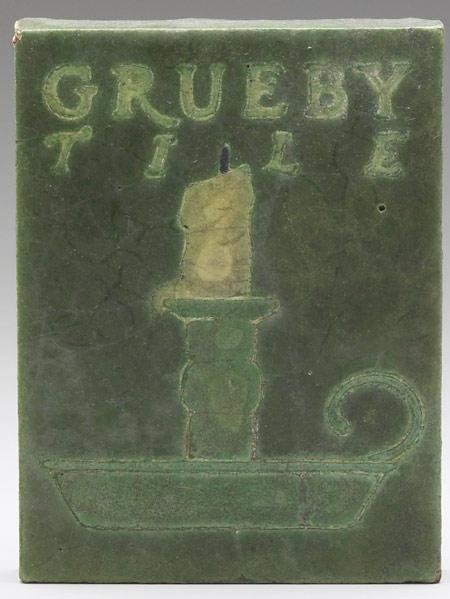 Appraisal: GRUEBY Advertising tile with candlesconce and yellow candle Slight clouding