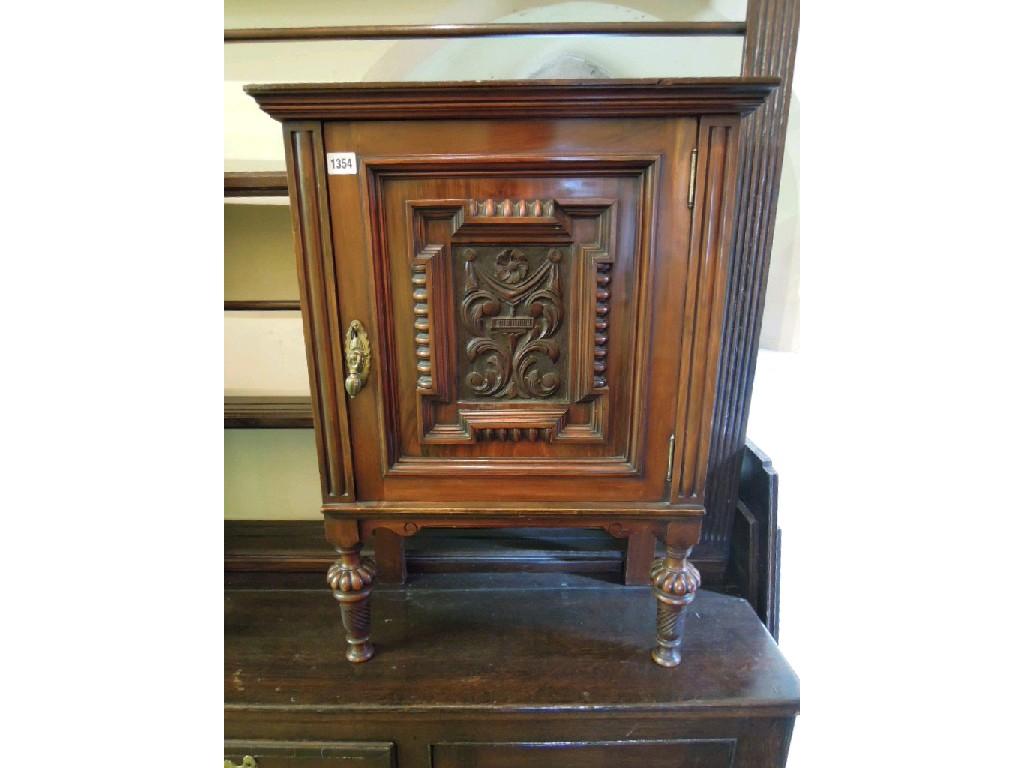 Appraisal: A pair of walnut side cupboards each enclosed by a