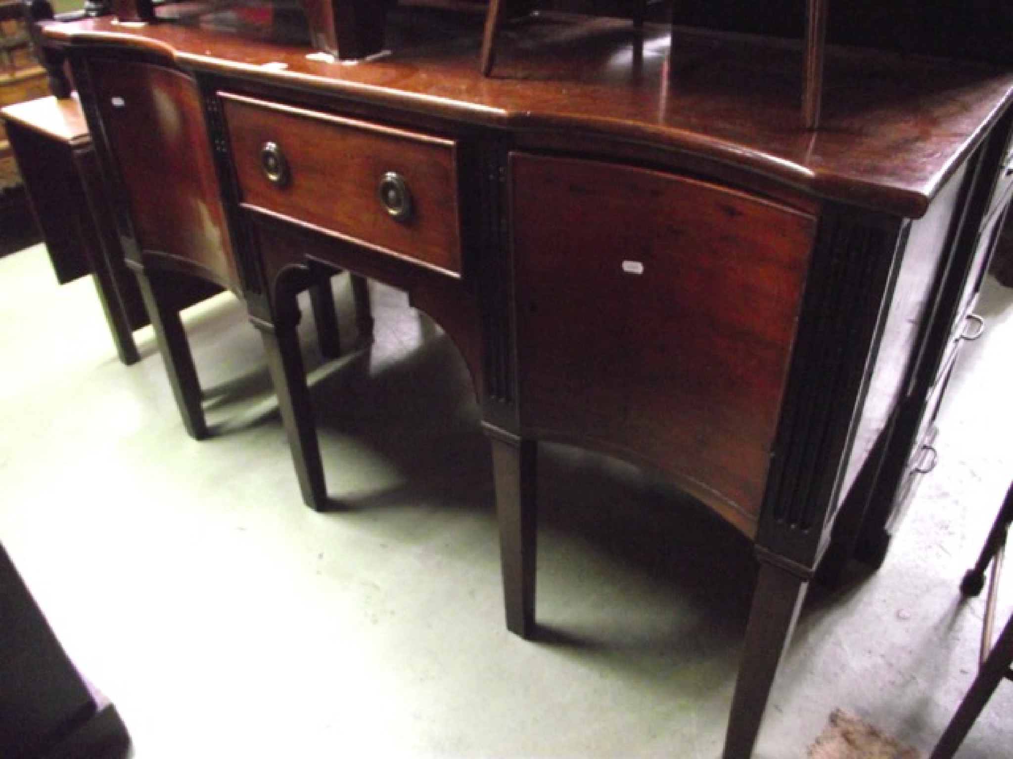 Appraisal: An Edwardian mahogany sideboard in the Georgian style fitted with