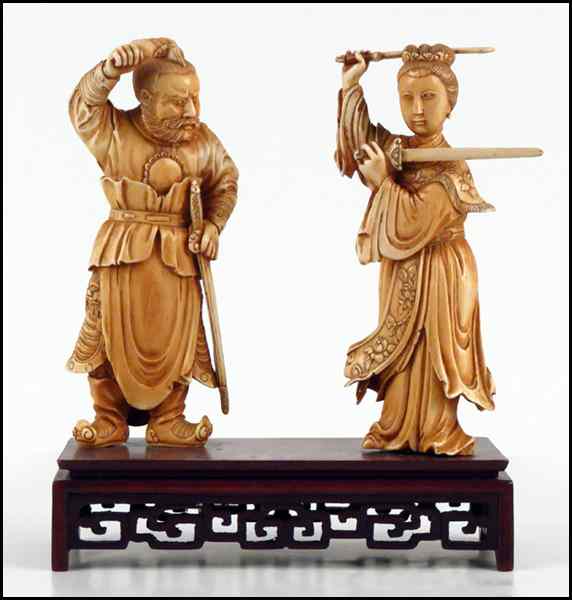 Appraisal: PAIR OF CARVED IVORY FIGURES OF A MAN AND WOMAN