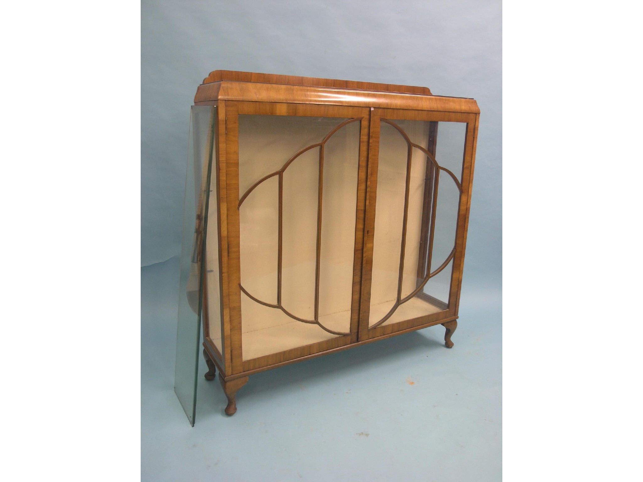 Appraisal: An Art Deco walnut veneered display cabinet two plate glass