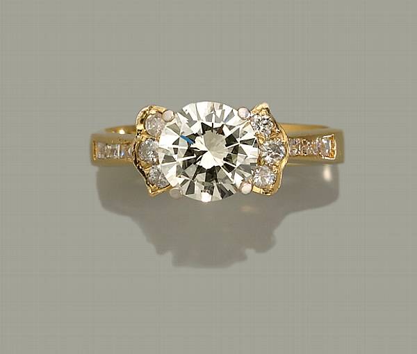 Appraisal: A diamond ring centering a round brilliant-cut diamond principal diamond