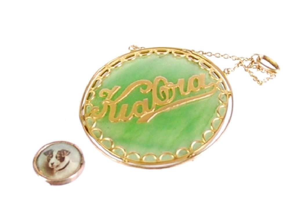 Appraisal: GREEN JADE CIRCULAR DISC PENDANT with gold frame and overlaid