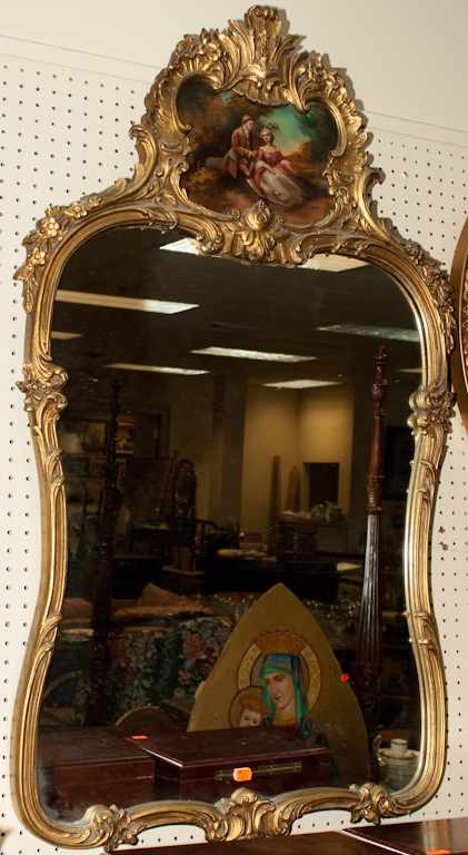 Appraisal: Rococo style giltwood mirror with inset oil painting of th